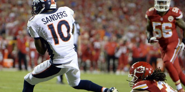 Sep 17, 2015; Kansas City, MO, USA; Denver Broncos wide receiver Emmanuel Sanders (10) catches a touchdown against the Kansas City Chiefs in the second half at Arrowhead Stadium. Denver won the game 31-24. Mandatory Credit: John Rieger-USA TODAY Sports