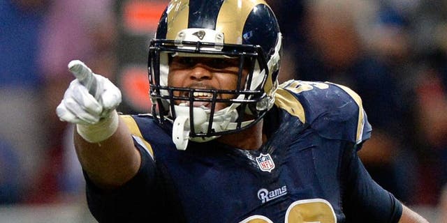 Sep 13, 2015; St. Louis, MO, USA; St. Louis Rams defensive tackle Aaron Donald (99) celebrates after sacking Seattle Seahawks quarterback Russell Wilson (not pictured) during the second half at the Edward Jones Dome. The Rams defeated the Seahawks 34-31 in overtime. Mandatory Credit: Jeff Curry-USA TODAY Sports
