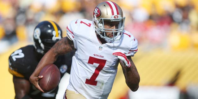 Sep 20, 2015; Pittsburgh, PA, USA; San Francisco 49ers quarterback Colin Kaepernick (7) scrambles with the ball as Pittsburgh Steelers outside linebacker James Harrison (92) chases during the fourth quarter at Heinz Field. The Steelers won 43-18. Mandatory Credit: Charles LeClaire-USA TODAY Sports