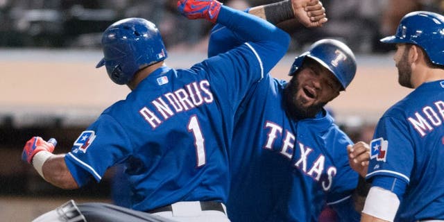Sep 23, 2015; Oakland, CA, USA; Texas Rangers shortstop Elvis Andrus (1) and designated hitter Prince Fielder (84) celebrate after Elvis hit a three run home run against the Oakland Athletics during the fourth inning at O.co Coliseum. Mandatory Credit: Ed Szczepanski-USA TODAY Sports
