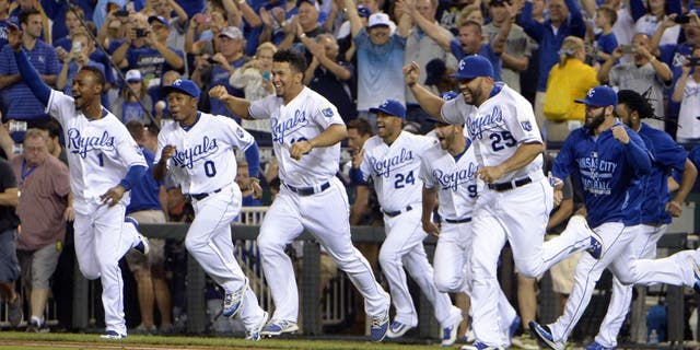 Sep 24, 2015; Kansas City, MO, USA; Kansas City Royals players celebrate after the game against the Seattle Mariners at Kauffman Stadium. Kansas City won the game 10-4 and won the American League central division. Mandatory Credit: John Rieger-USA TODAY Sports