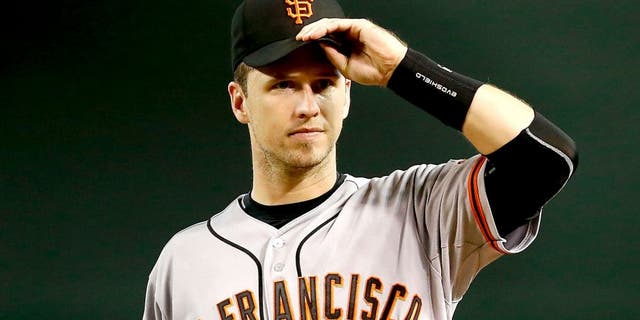 Buster Posey #28 of the San Francisco Giants leaves the field during an MLB game against the Arizona Diamondbacks on September 7, 2015 at Chase Field in Phoenix, Arizona.