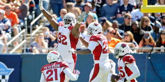 CHICAGO, IL - SEPTEMBER 20: Tony Jefferson #22 of the Arizona Cardinals celebrates with Frostee Rucker #92 and Patrick Peterson #21 after making an interception for a touchdown against the Chicago Bears during the second quarter at Soldier Field on September 20, 2015 in Chicago, Illinois. (Photo by Jon Durr/Getty Images)