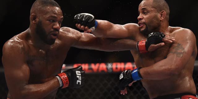 LAS VEGAS, NV - JANUARY 03: Jon Jones (L) and Daniel Cormier (R) exchange punches in their UFC light heavyweight championship bout during the UFC 182 event at the MGM Grand Garden Arena on January 3, 2015 in Las Vegas, Nevada. (Photo by Jeff Bottari/Zuffa LLC/Zuffa LLC via Getty Images)