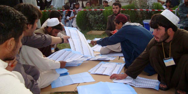 Sept. 20: Election workers count votes at the regional counting center in Khost, Afghanistan.