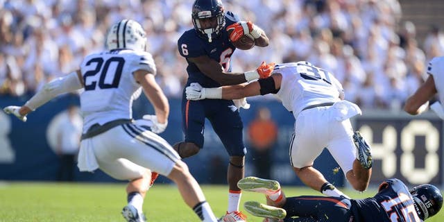Sep 20, 2014; Provo, UT, USA; Virginia Cavaliers wide receiver Darius Jennings (6) shakes the tackle of Brigham Young Cougars linebacker Sae Tautu (31) during the second half at Lavell Edwards Stadium. The Cougars won the game 41-33. Mandatory Credit: Joe Camporeale-USA TODAY Sports