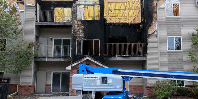 In this Sept. 14, 2016, photo, restoration work is performed at a Bellevue, Neb., apartment complex which was hit twice by fire.