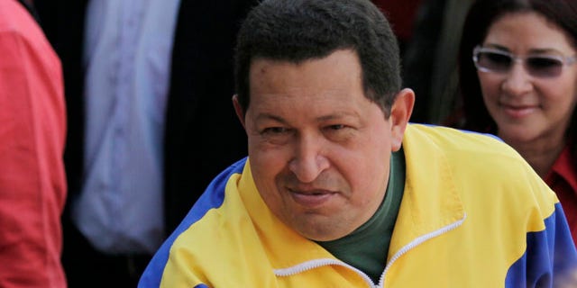 Sept. 26: Venezuela's President Hugo Chavez greets supporters upon his arrival to a polling station during congressional elections in Caracas, Venezuela.
