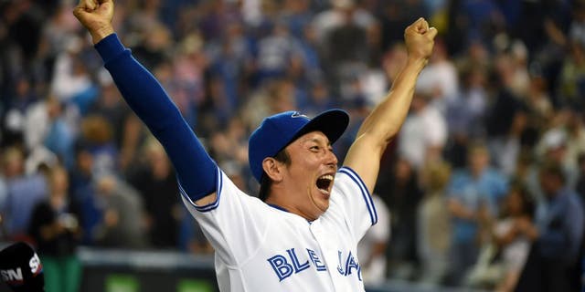 Sep 2, 2015; Toronto, Ontario, CAN; Toronto Blue Jays infielder Munenori Kawasaki (66) reacts to fans cheers during post-game celebrations afterthe Jays defeated Cleveland Indians 5-1 at Rogers Centre. Mandatory Credit: Dan Hamilton-USA TODAY Sports