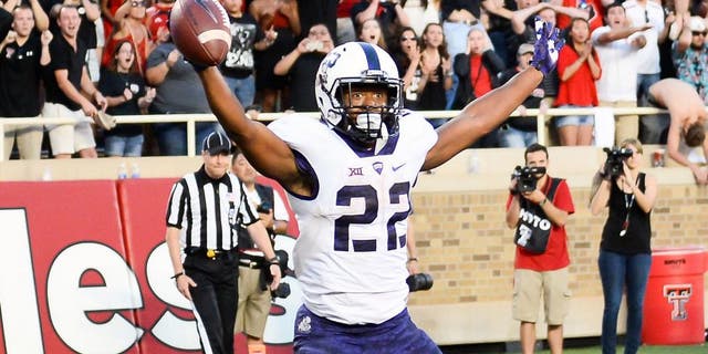 LUBBOCK, TX - SEPTEMBER 26: Aaron Green #22 of the TCU Horned Frogs catches a tipped ball in the end zone for the game winning touchdown late in the 4th quarter against the Texas Tech Red Raiders on September 26, 2015 at Jones AT&T Stadium in Lubbock, Texas. TCU won the game 55-52. (Photo by John Weast/Getty Images)