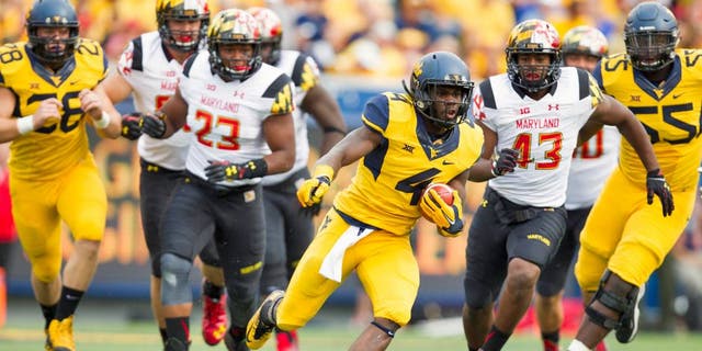 Sep 26, 2015; Morgantown, WV, USA; West Virginia Mountaineers running back Wendell Smallwood runs the ball against the Maryland Terrapins during the first quarter at Milan Puskar Stadium. Mandatory Credit: Ben Queen-USA TODAY Sports