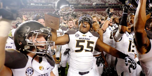 COLUMBIA, SC - SEPTEMBER 27: Offensive Lineman Nate Crawford #55 of the Missouri Tigers hoists the Mayor's Cup after the game against the South Carolina Gamecocks on September 27, 2014 at Williams-Brice Stadium in Columbia, South Carolina. Missouri won 21-20. (Photo by Todd Bennett/GettyImages)