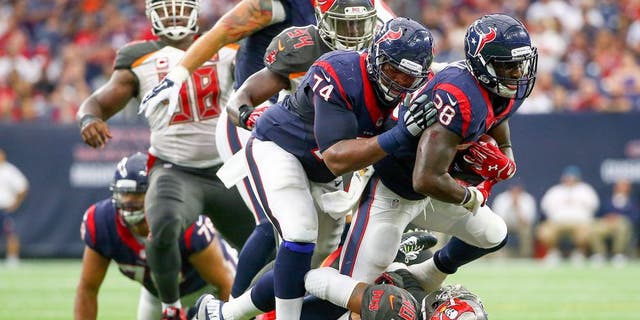 Sep 27, 2015; Houston, TX, USA; Houston Texans running back Alfred Blue (28) runs over Tampa Bay Buccaneers free safety Bradley McDougald (30) during the first half at NRG Stadium. Mandatory Credit: Kevin Jairaj-USA TODAY Sports