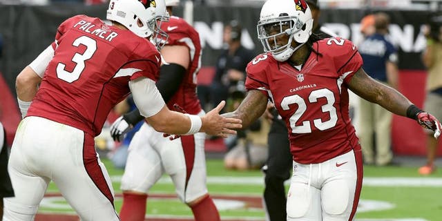 GLENDALE, AZ - SEPTEMBER 27: Chris Johnson #23 of the Arizona Cardinals celebrates with teammate Carson Palmer #3 after scoring a touchdown during the first half against the San Francisco 49ers at University of Phoenix Stadium on September 27, 2015 in Glendale, Arizona. (Photo by Norm Hall/Getty Images)