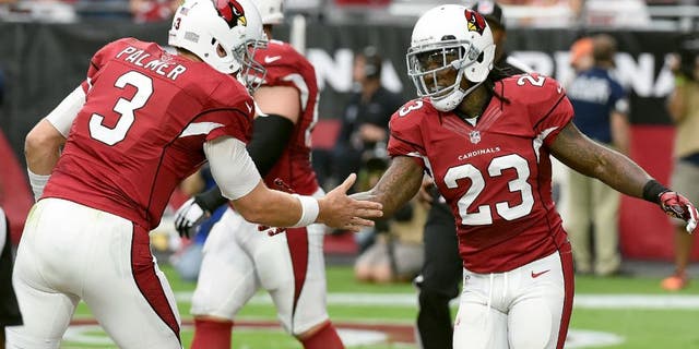 GLENDALE, AZ - SEPTEMBER 27: Chris Johnson #23 of the Arizona Cardinals celebrates with teammate Carson Palmer #3 after scoring a touchdown during the first half against the San Francisco 49ers at University of Phoenix Stadium on September 27, 2015 in Glendale, Arizona. (Photo by Norm Hall/Getty Images)
