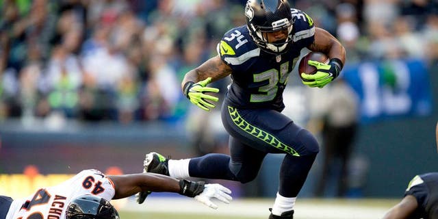 Sep 27, 2015; Seattle, WA, USA; Seattle Seahawks running back Thomas Rawls (34) breaks away from Chicago Bears linebacker Sam Acho (49) during the third quarter at CenturyLink Field. The Seahawks won 26-0. Mandatory Credit: Troy Wayrynen-USA TODAY Sports