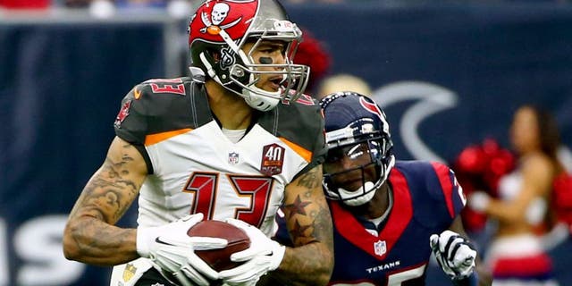 Sep 27, 2015; Houston, TX, USA; Tampa Bay Buccaneers wide receiver Mike Evans (13) runs with the ball as Houston Texans cornerback Kareem Jackson (25) defends during the game at NRG Stadium. Houston won 19-9. Mandatory Credit: Kevin Jairaj-USA TODAY Sports