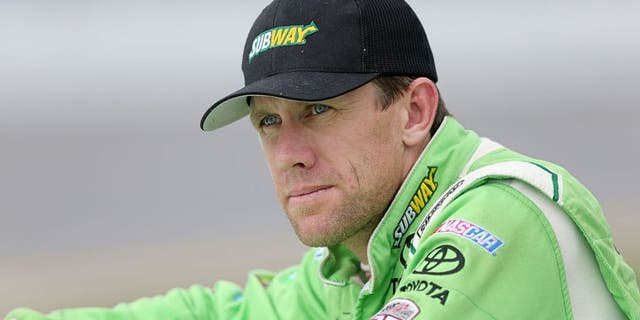 DAYTONA BEACH, FL - JULY 01: Carl Edwards, driver of the #19 Subway Toyota, stands on the grid during qualifying for the NASCAR Sprint Cup Series Coke Zero 400 at Daytona International Speedway on July 1, 2016 in Daytona Beach, Florida. (Photo by Jerry Markland/Getty Images)