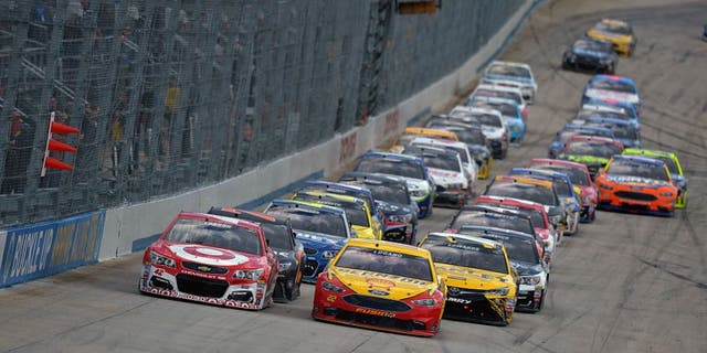 DOVER, DE - MAY 15: Kyle Larson, driver of the #42 Target Chevrolet, and Joey Logano, driver of the #22 Shell Pennzoil Ford, lead the pack during the NASCAR Sprint Cup Series AAA 400 Drive for Autism at Dover International Speedway on May 15, 2016 in Dover, Delaware. (Photo by Drew Hallowell/NASCAR via Getty Images)
