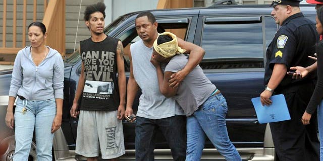 Sept. 28: Friends of shooting victims grieve in Boston near the scene of an early morning shooting where five people, including a toddler, were shot in the Mattapan neighborhood of Boston.