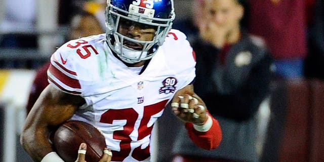Sep 25, 2014; Landover, MD, USA; New York Giants free safety Quintin Demps (35) runs with the ball after an interception against the Washington Redskins during the second half at FedEx Field. Mandatory Credit: Brad Mills-USA TODAY Sports