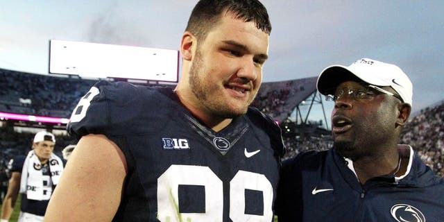 Sep 26, 2015; University Park, PA, USA; Penn State Nittany Lions defensive tackle Anthony Zettel (98) receives a hug from defensive line coach Sean Spencer (right) following the completion of the game against the San Diego State Aztecs at Beaver Stadium. Penn State defeated San Diego State 37-21. Mandatory Credit: Matthew O'Haren-USA TODAY Sports