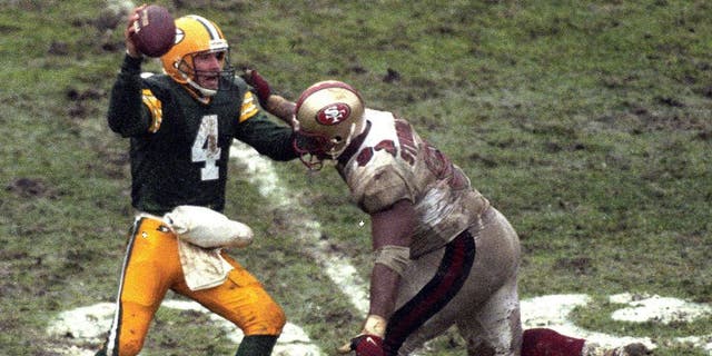 Brett Favre #4 of the Green Bay Packers looks to pass during the NFL Divisional Playoff Game against the San Francisco 49ers on January 4, 1997 in Green Bay, Wisconsin.