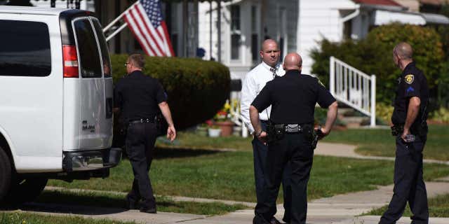 Police investigate at a home where two children were shot in Dearborn, Mich., Wednesday, Sept. 27, 2017.