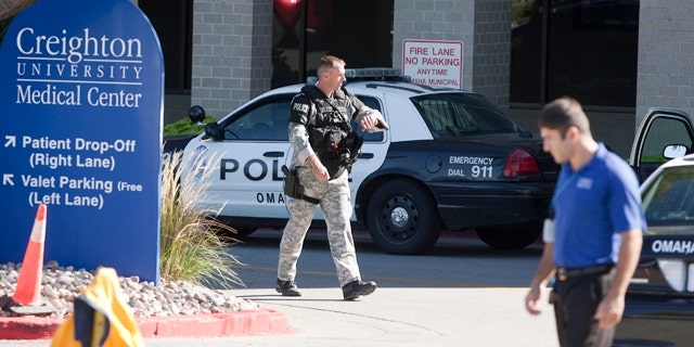 Sept. 29: A police SWAT team member walks out of the Creighton University medical center in Omaha, Neb.