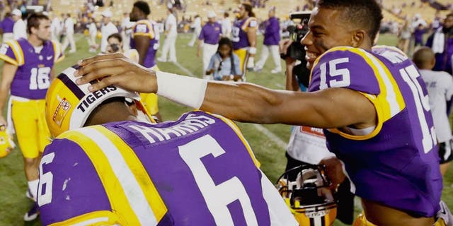 Sep 27, 2014; Baton Rouge, LA, USA; LSU Tigers wide receiver Malachi Dupre (15) and quarterback Brandon Harris (6) celebrate following a win against the New Mexico State Aggies in a game at Tiger Stadium. LSU defeated New Mexico State 63-7. Mandatory Credit: Derick E. Hingle-USA TODAY Sports
