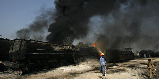 Oct. 1: Firemen extinguish a fire on a burning oil tanker on a highway near Shikarpur, in Pakistan's Sindh province. Suspected militants set fire to tankers carrying fuel for NATO troops in Afghanistan.