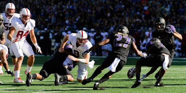 Sep 27, 2014; Seattle, WA, USA; Washington Huskies defensive back Budda Baker (32) reaches for the fumbled ball by Stanford Cardinal safety Jordan Richards (8) during the second half at Husky Stadium. Stanford defeated Washington 20-13. Mandatory Credit: Steven Bisig-USA TODAY Sports