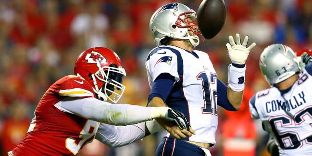 KANSAS CITY, MO - SEPTEMBER 29: Tamba Hali #91 of the Kansas City Chiefs knocks the ball loose from Tom Brady #12 of the New England Patriots for a fumble during the third quarter at Arrowhead Stadium on September 29, 2014 in Kansas City, Missouri. (Photo by Dilip Vishwanat/Getty Images)