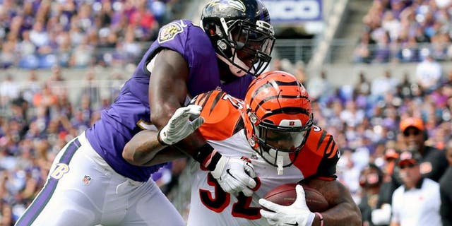 Sep 27, 2015; Baltimore, MD, USA; Cincinnati Bengals running back Jeremy Hill (32) tackled by Baltimore Ravens linebacker C.J. Mosley (57) at M&T Bank Stadium. Mandatory Credit: Mitch Stringer-USA TODAY Sports