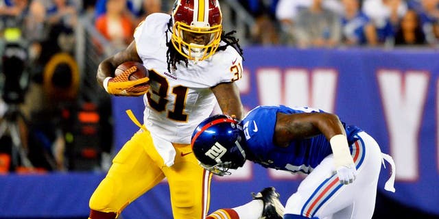 EAST RUTHERFORD, NJ - SEPTEMBER 24: Matt Jones #31 of the Washington Redskins tries to avoid the tackle of Landon Collins #21 of the New York Giants in the second quarter at MetLife Stadium on September 24, 2015 in East Rutherford, New Jersey. (Photo by Alex Goodlett/Getty Images)