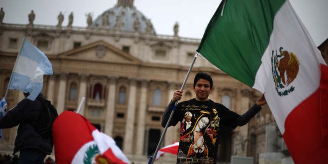 VATICAN CITY, VATICAN - MARCH 17: A boy waves the flag of Mexico in St Peter's Square after Pope Francis gave his first Angelus blessing on March 17, 2013 in Vatican City, Vatican. The Vatican is preparing for the inauguration of Pope Francis on March 19, 2013 in St Peter's Square. (Photo by Peter Macdiarmid/Getty Images)
