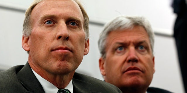 FILE - In this Jan. 24, 2013 file photo, John Idzik, left, sits next to New York Jets head coach Rex Ryan while waiting to be introduced as the Jets new general manager during an NFL football news conference in Florham Park, N.J. Idzik's first headline-making move as the Jets' general manager was trading away his best player. Idzik will now try to find a few guys who can help get the franchise _ which was a win away from the Super Bowl in the 2009 and ’10 seasons _ back on track. (AP Photo/Julio Cortez, File)