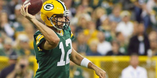 Green Bay Packers quarterback Aaron Rodgers (12) passes against the Seattle Seahawks during the first quarter at Lambeau Field. Packers won 27-17.