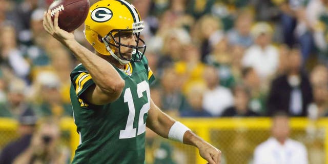 Green Bay Packers quarterback Aaron Rodgers (12) passes against the Seattle Seahawks during the first quarter at Lambeau Field.  Packers won 27-17.