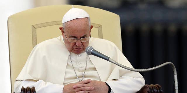 Pope Francis pauses during the weekly general audience in St. Peter's Square, at the Vatican, Wednesday, Nov. 12, 2014. (AP Photo/Gregorio Borgia)
