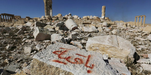 File photo - Graffiti sprayed by Islamic State militants which reads "We remain" is seen on a stone at the Temple of Bel in the historic city of Palmyra, in Homs Governorate, Syria April 1, 2016.