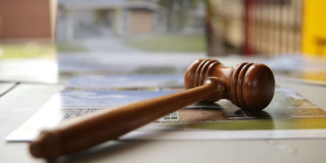 BLACKTOWN, AUSTRALIA - FEBRUARY 14: An auctioneer's gavel is seen prior to the home auction for a four-bedroom house at 230 Blacktown Road on February 14, 2015 in Blacktown, Australia. The Blacktown home sold for AUD$565,000 at auction today, smashing the reserve set at AUD$1. The Sydney home auction clearance rate is expected to remain high following the Reserve Bank's interest rate cut to 2.25 per cent last week. (Photo by Mark Metcalfe/Getty Images)