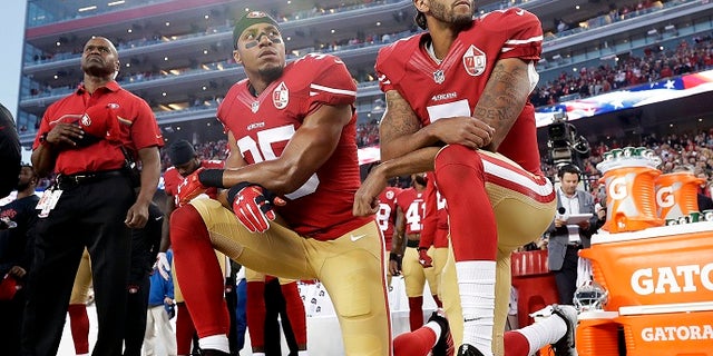 In this Monday, Sept. 12, 2016, file photo, San Francisco 49ers safety Eric Reid (35) and quarterback Colin Kaepernick (7) kneel during the national anthem before a game against the Los Angeles Rams in Santa Clara, Calif.