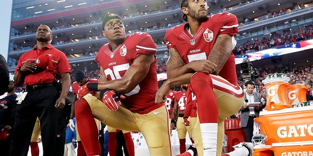 In this Monday, Sept. 12, 2016, file photo, San Francisco 49ers safety Eric Reid (35) and quarterback Colin Kaepernick (7) kneel during the national anthem before a game against the Los Angeles Rams in Santa Clara, Calif.