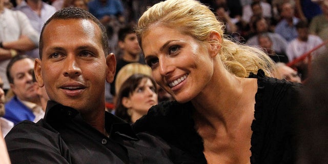 MIAMI, FL - JANUARY 17: Baseball player Alex Rodriguez (L) of the New York Yankees and Torrie Wilson watch a game between the Miami Heat and the San Antonio Spurs at American Airlines Arena on January 17, 2012 in Miami, Florida. NOTE TO USER: User expressly acknowledges and agrees that, by downloading and/or using this Photograph, User is consenting to the terms and conditions of the Getty Images License Agreement. (Photo by Mike Ehrmann/Getty Images)