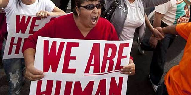Jan. 16: Protesters yell while marching down 35th Avenue in protest against Sheriff Joe Arpaio.