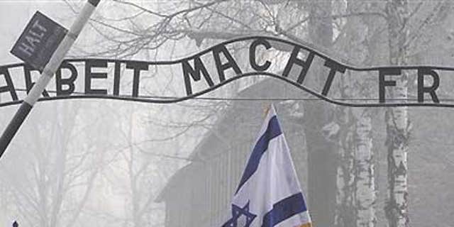 Jan. 27: Visitors under the infamous Arbeit Macht Frei 'Work Sets You Free' sign over the main gate of Auschwitz.