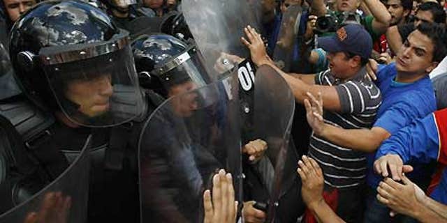 Feb. 4: University students clash with police during a protest against Venezuela's President Hugo Chavez in Caracas.