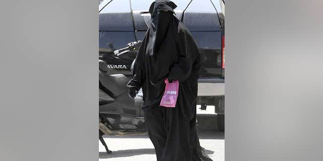 File: An unidentified woman wears Muslim style dress, with only her eyes visible, in Marseille, southern France.
