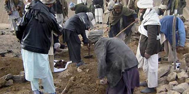 Feb. 17: Afghans dig graves for the victims who villagers said were killed in an airstrike, in Gozara district of Herat province, west of Kabul.